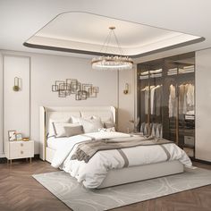 a large white bed sitting in a bedroom next to a walk in closet with clothes on hangers