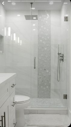 a white bathroom with a walk in shower next to a toilet and bathtub area