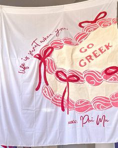 there is a white banner with red writing on it that says go creek and pink ribbon