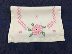 a white cloth with pink flowers on it