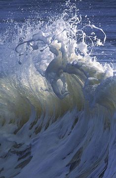 an ocean wave with white foam on it