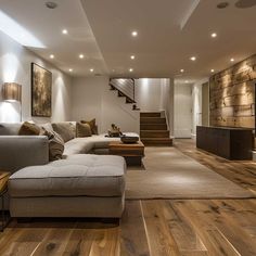 a living room filled with lots of furniture and wooden flooring next to a stair case