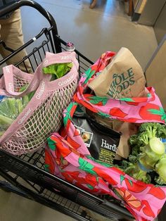 a shopping cart filled with grocery bags and groceries