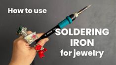 a person holding an item in their hand with the text how to use soldering iron for jewelry