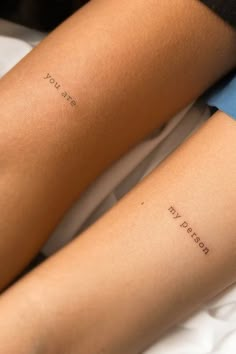 two people with matching tattoos on their arms, one has the word love written on it