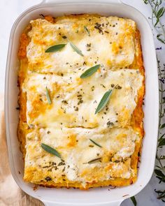 a casserole dish with cheese and herbs