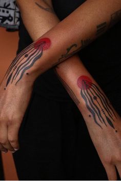 two people with matching tattoos on their arms