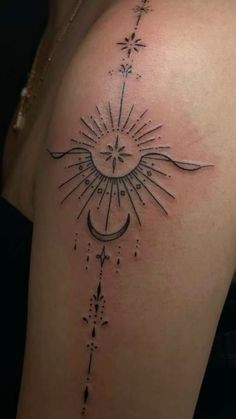 a woman's back with a sun and moon tattoo on it