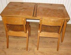 two wooden desks sitting on top of a hard wood floor next to each other