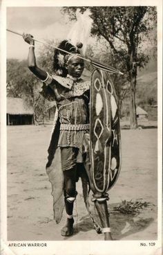 an african warrior holding a spear and shield