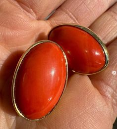 --Stone(s):-- (2) Natural Genuine Corals - Oval Cabochon Cut - Bezel Set -  Reddish Orange Color - 28.94ctw (exact, certified) ** See Certification Details Below for Complete Info ** Material: Solid 18k Yellow Gold Weight: 11.58 Grams Backing: Posts w/ Omega Closures (Pierced ears are required.) Length: 23.5mm (0.92") Width: 15.4mm (0.60") Thickness: 8.9mm (at the coral) projection off the ear Condition: Vintage stones. New earrings. Comes with the original GIA certification for both of the cora Classic Oval Gemstone Cabochons, Luxury High Luster Oval Earrings, Oval Gemstones With Polished Finish For Formal Occasions, Oval Cabochons For Formal Wear Fine Jewelry, Oval Polished Gemstones For Formal Occasions, Luxury Red Oval Earrings, Oval Gemstone Earrings For Formal Occasions, Elegant Red Cabochon Gemstones, Formal Oval Clip-on Earrings