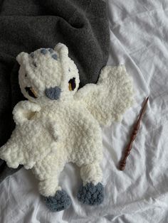 a crocheted stuffed animal laying on top of a bed