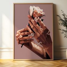 a woman's hand holding a rose with jewelry on it