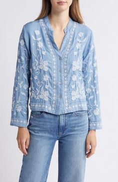 This lightweight chambray button-up shirt covered in intricate floral embroidery is the perfect layering piece all year 'round. Front button closure V-neck Long sleeves 100% cotton Hand wash, dry flat Made in the USA Bohemian Embroidered Button-up Tops, Spring Long Sleeve Tops With Chikankari Embroidery, Light Blue Shirt With Button Closure For Spring, Spring Embroidered Light Wash Tops, Spring Light Wash Embroidered Tops, Spring Bohemian Button-up Tops, Light Wash Embroidered Tops For Spring, Light Blue Embroidered Tops For Spring, Light Wash Tops With Button Closure For Spring