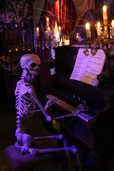 a skeleton playing the piano in a dark room