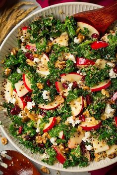 a salad with apples, kale and feta cheese