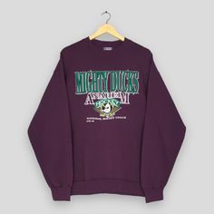 Vintage 90s Anaheim Mighty Ducks NHL Sweatshirt Large Mighty Ducks Anaheim Hockey Sweater Anaheim Ducks American Ica Hockey Crewneck Size L Good Used Condition. No Stains and No Holes. Size (On Tag) : Size L **To make sure if it FITS YOU, refer at the exact measurements. Size Measurement (All measurements were taken lying flat) : Width [armpit to armpit] : 21.5 inches / 55 cm Length [shoulder to end of garment] : 26 inches / 66 cm THIS IS USED CLOTHING! PLEASE DON`T EXPECTED IT TO BE LIKE NEW OR Anaheim Ducks Outfit, Hockey Crewneck, Hockey Sweater, Mighty Ducks, Movie Inspired Outfits, 90s Shirts, Southern Shirts, Anaheim Ducks, Really Cute Outfits