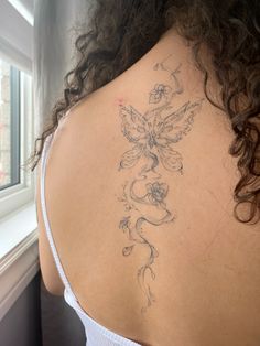 a woman with a tattoo on her back