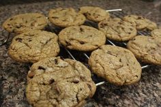 chocolate chip cookies cooling on a rack on a counter top, ready to be eaten