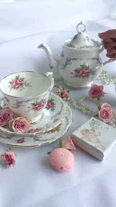 tea set with pink roses and pearls on the table