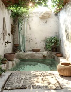 an indoor pool with plants and potted plants in the corner, surrounded by stone walls