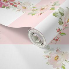 a pink and white floral wallpaper with flowers on the side, next to a roll of tape