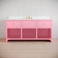 a pink vanity with scalloped edges and two faucets on the sink