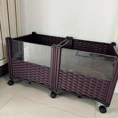 two wicker baskets sitting next to each other on top of a tile floor in front of a radiator