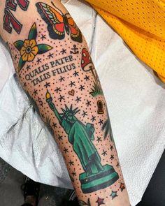 the statue of liberty tattoo is on someone's arm