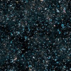 black and blue speckles are scattered on the ground in this image, as if they were from above