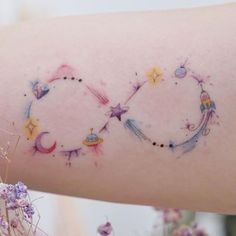 a woman's arm with the word love written on it and stars in the middle