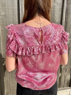 Life's a party and you'll be center stage in this sassy sequin top! Whether you choose vibrant pink or subtle taupe, you'll be ready to dance the night away with its short sleeves and flirty ruffle detail. Get the life of the party look in this fun top! 95% Polyester 5R% Elastane Chic Pink Party Top, Fitted Shimmer Tops For Date Night, Glamorous Glitter Tops For Summer, Fitted Sequined Tops For Holiday Party, Sequined Tops For Date Night And Party Season, Flirty Pink Short Sleeve Tops, Glamorous Sequin Tops For Night Out, Glamorous Short Sleeve Blouse, Glitter Tops For Night Out In Spring