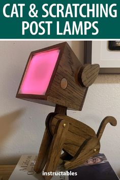 a wooden cat sitting on top of a table next to a pink light in the shape of a post lamp