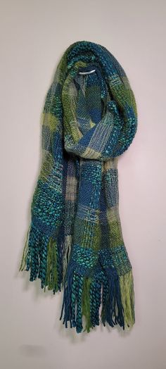 a green and blue scarf hanging on a wall