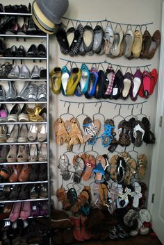 there are many pairs of shoes hanging on the wall