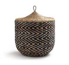 a woven basket with a lid and handle on the top, sitting in front of a white background