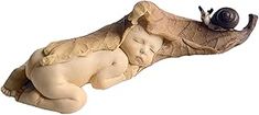 a statue of a sleeping baby with a snail on it's back