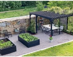 an outdoor patio with several planters and tables in the foreground, surrounded by stone walls