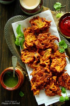 some food is sitting on a plate with dipping sauce