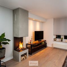 a living room filled with furniture and a fire place in front of a flat screen tv