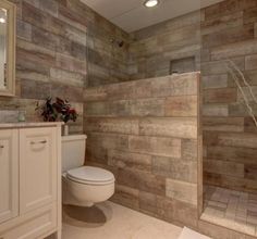 a bathroom with wooden walls and tile flooring