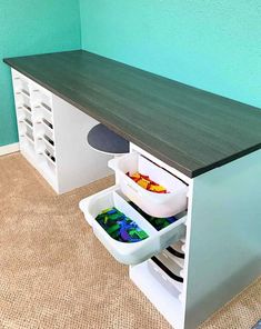 a kitchen counter with two bins filled with food and one drawer full of containers