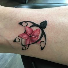 a woman's arm with a flower tattoo on it