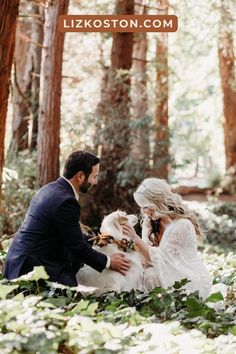 a man kneeling down next to a woman in a forest