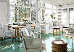 a living room filled with furniture and lots of windows