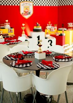 the table is set with black and white plates, red napkins, and silverware