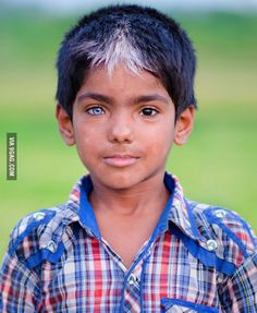 a young boy with blue eyes is looking at the camera and has a caption that reads peculaidad genetica