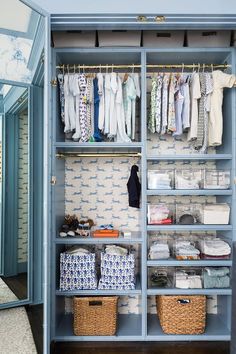 an organized closet with clothes and baskets