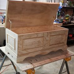 an unfinished chest sitting on top of a workbench