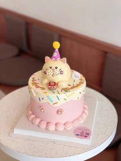 a birthday cake with a cat on top